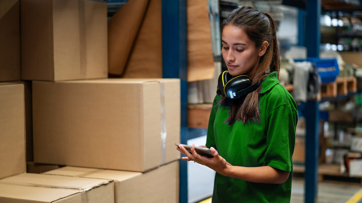 A woman checking inventory in a warehouse