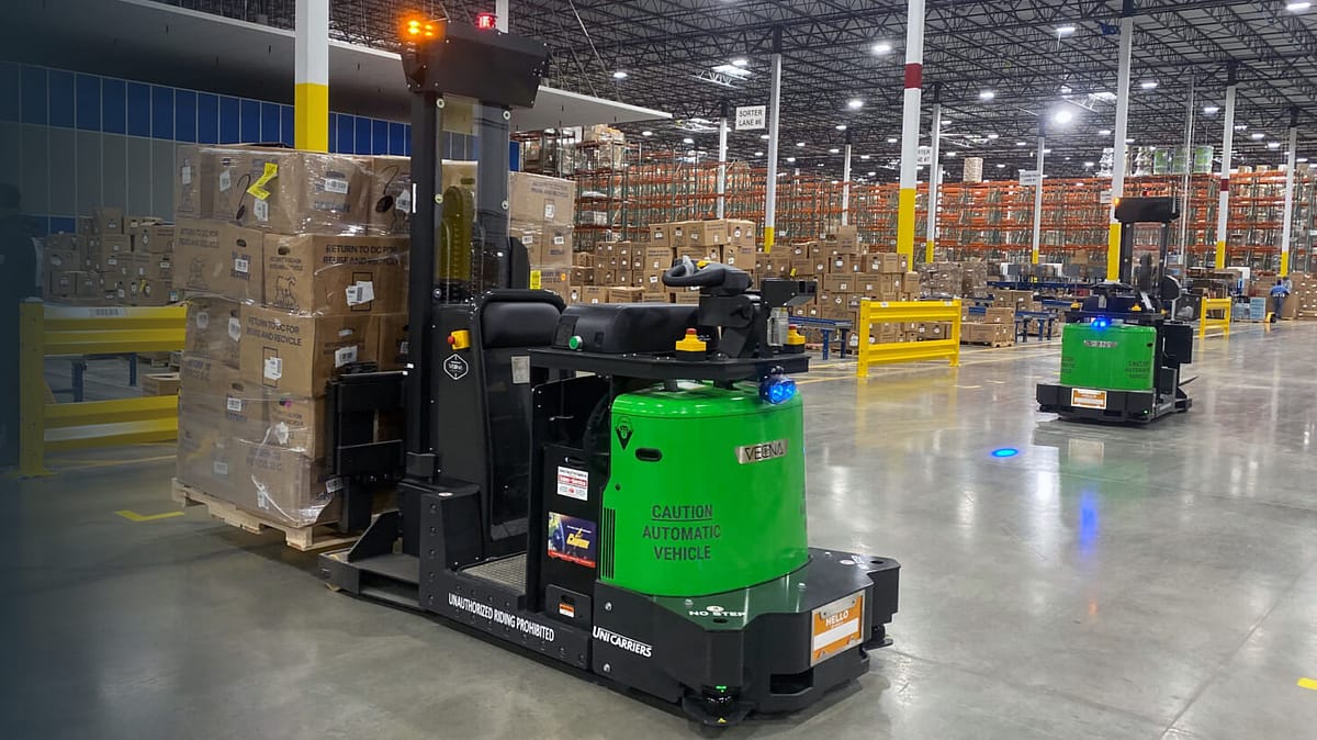 A photo of an AMR moving a pallet of boxes