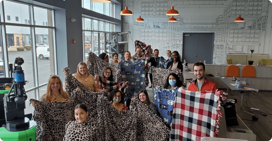 Photo of people holding up blankets